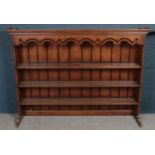 A large carved oak dresser top fitted with three shelves. (H130cm x W183cm x D38cm)