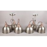 A pair of three armed industrial style ceiling lights. Comprising of copper affect detailing and