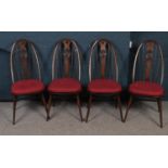 Four Ercol swan back dining chairs. (100cm height, 44cm width)