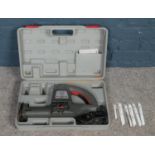 A cased 'Performance' multipurpose hand-held saw, together with a selection of blades. Condition