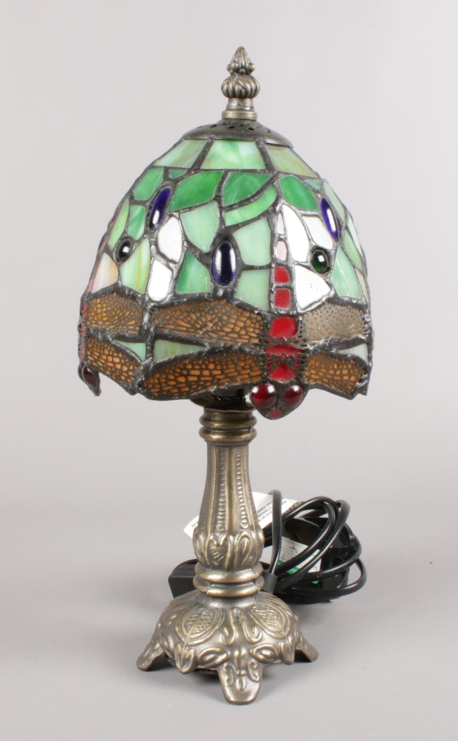 A Tiffany style dragon fly table lamp. (32cm height) Some of the glass has cracked on the shade.