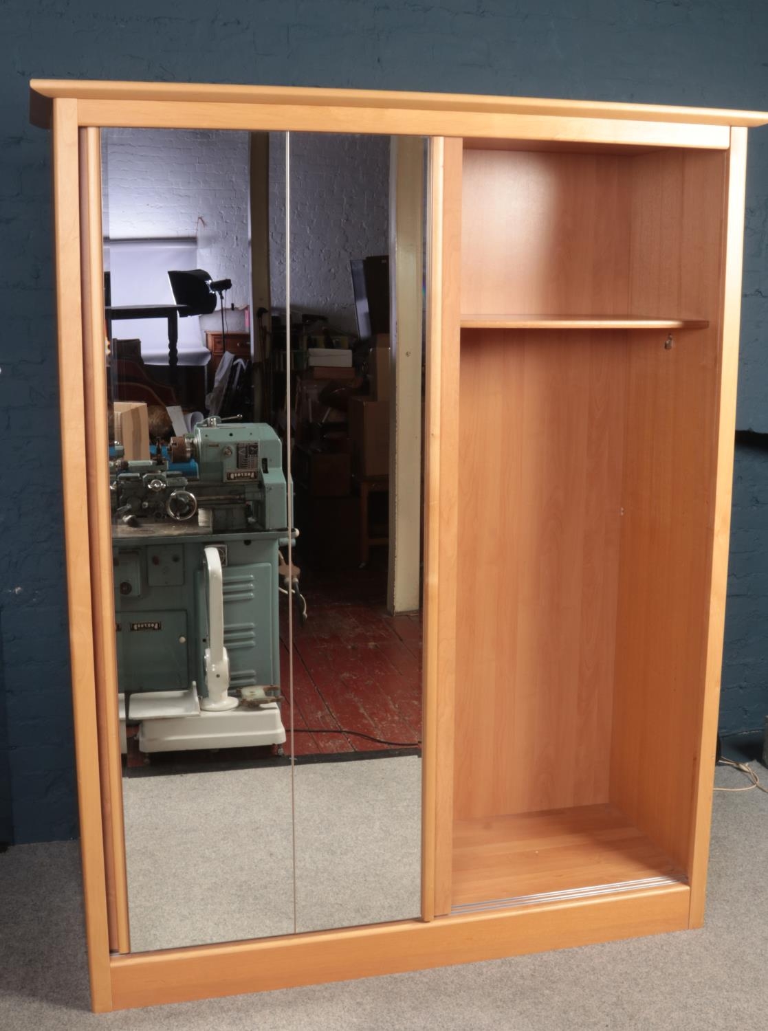 A large Beechwood double wardrobe with twin sliding mirrored doors (164cm width, 214cm height, 62.