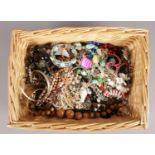 A basket of costume jewellery. Includes beads, pendants, bracelets etc.