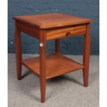 A Legate teak side table with single drawer and under tier.