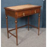 A mahogany writing desk raised on turned supports. Missing leather inset top.