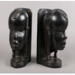 A pair of carved and ebonised book ends. African tribal busts.