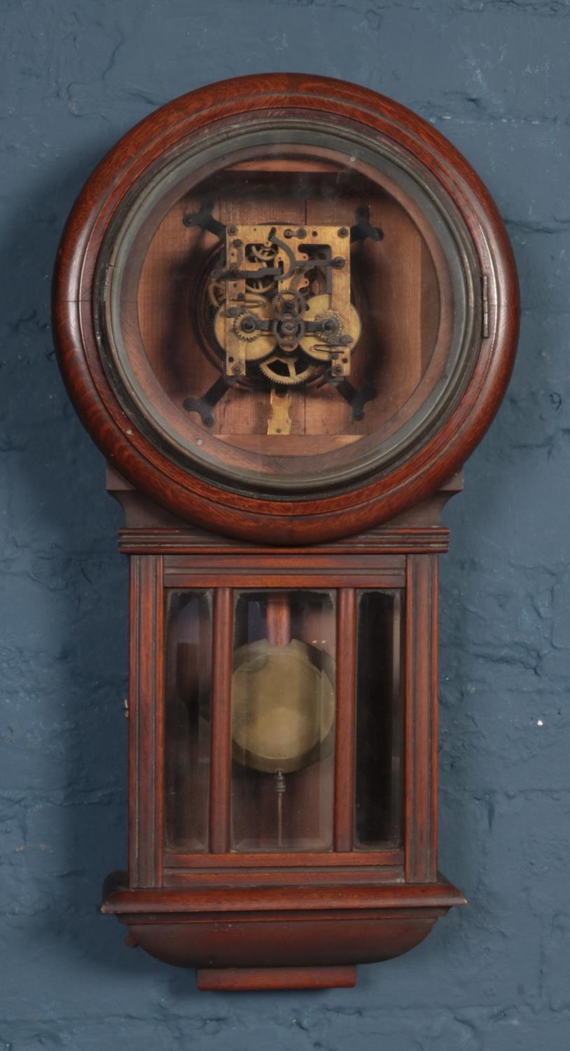 An oak cased eight day drop dial wall clock. No dial.