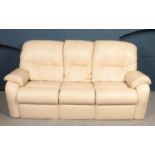 A 'G-Plan' three seater sofa together with two matching electric recliners in cream leather. Sofa: