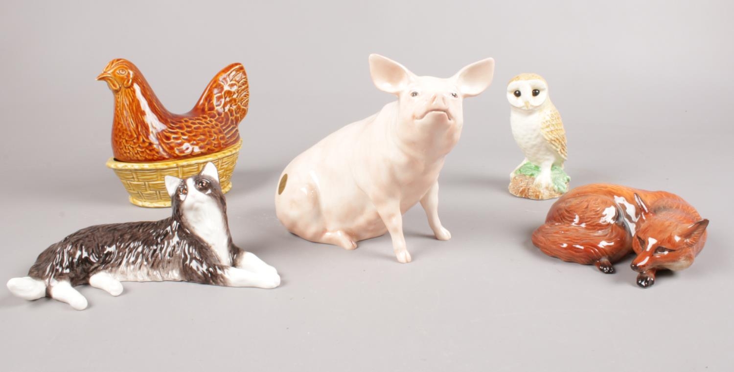 A group of Beswick figures. Pig sitting, Fox lying, Barn Owl, Hen in Basket, Long Haired Cat. (