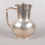 A Elkington & Co silver plated water jug designed by Dr. Christopher Dresser. C. 1865, circular