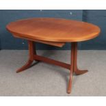 A Parker Knoll teak extending dining table and six matching chairs.