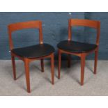 A pair of retro teak chairs. With vinyl covered seats.