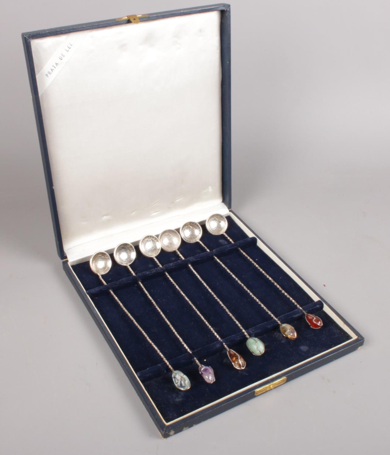 A set of 6 Brazilian silver 2000 reis coin spoons. With white metal twisted shafts and assorted