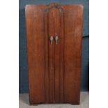 A carved oak fitted gentleman's fitted wardrobe. (180cm x 92cm)