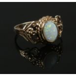 A 9ct gold opal ring with open work shoulders. Size N. 2.45g.