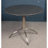 A circular granite topped bistro table & two leatherette chairs. Table: H: 75cm, D:90cm. Condition