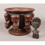 An African carved wooden bowl and similar figure. Bowl with tribal mask decoration. (Bowl height