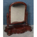 A carved mahogany toilet mirror with drawer base. Some woodworm. Knocks to wood. Frame loose along