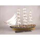 A wooden scale model of 'The Cutty Sark' - to include lifeboats and rigging. H: 68cm, W: 87cm.