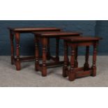 A set of three Oak nest of tables. Comprising of turned legs. H:47cm,W:60.5cm, D:34cm. Condition