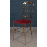 A brass Chiavari hall chair. Wear to seat.