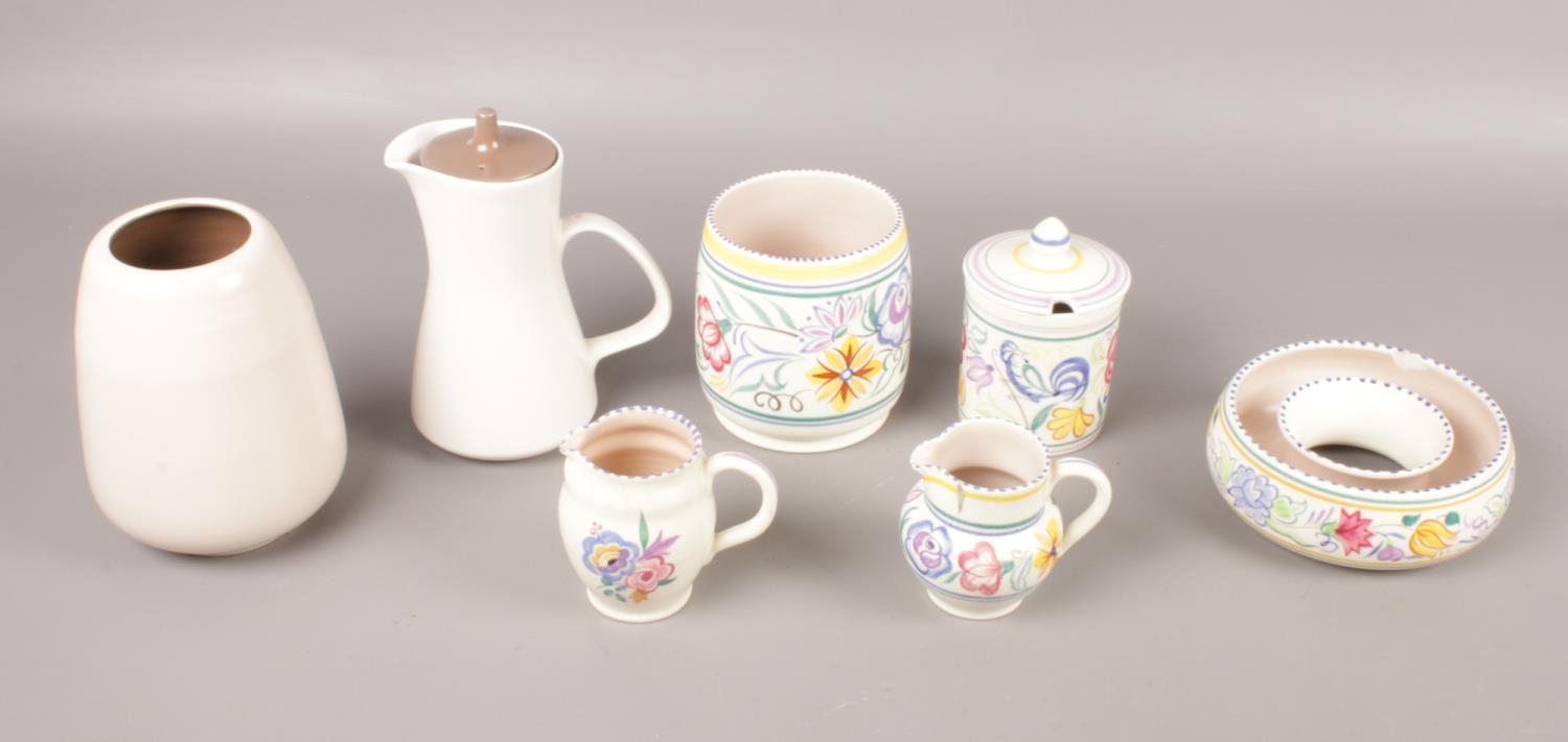 Seven pieces of Poole Pottery in two designs. To include a lidded honey pot, two vases and two small