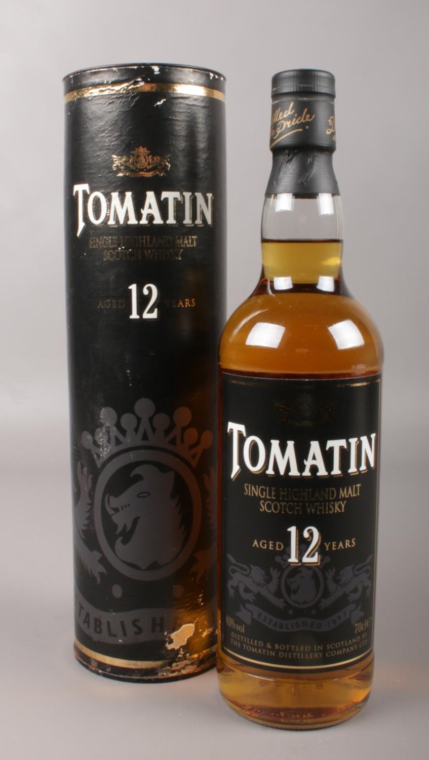 A bottle of Tomatin single Highland malt scotch whisky. Aged 12 years, 70cl. In presentation tube.