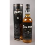 A bottle of Tomatin single Highland malt scotch whisky. Aged 12 years, 70cl. In presentation tube.