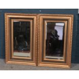 A pair of large gilt framed beveledge wall mirrors. (85cm x 54cm)