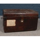 A vintage dome top twin handled tin trunk.