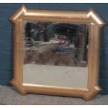 A gilt framed beveledge wall mirror. (72cm x 72cm)