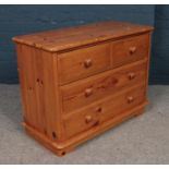 A pine chest of two over two drawers. (Height 64cm, Width 85cm, Depth 38cm).