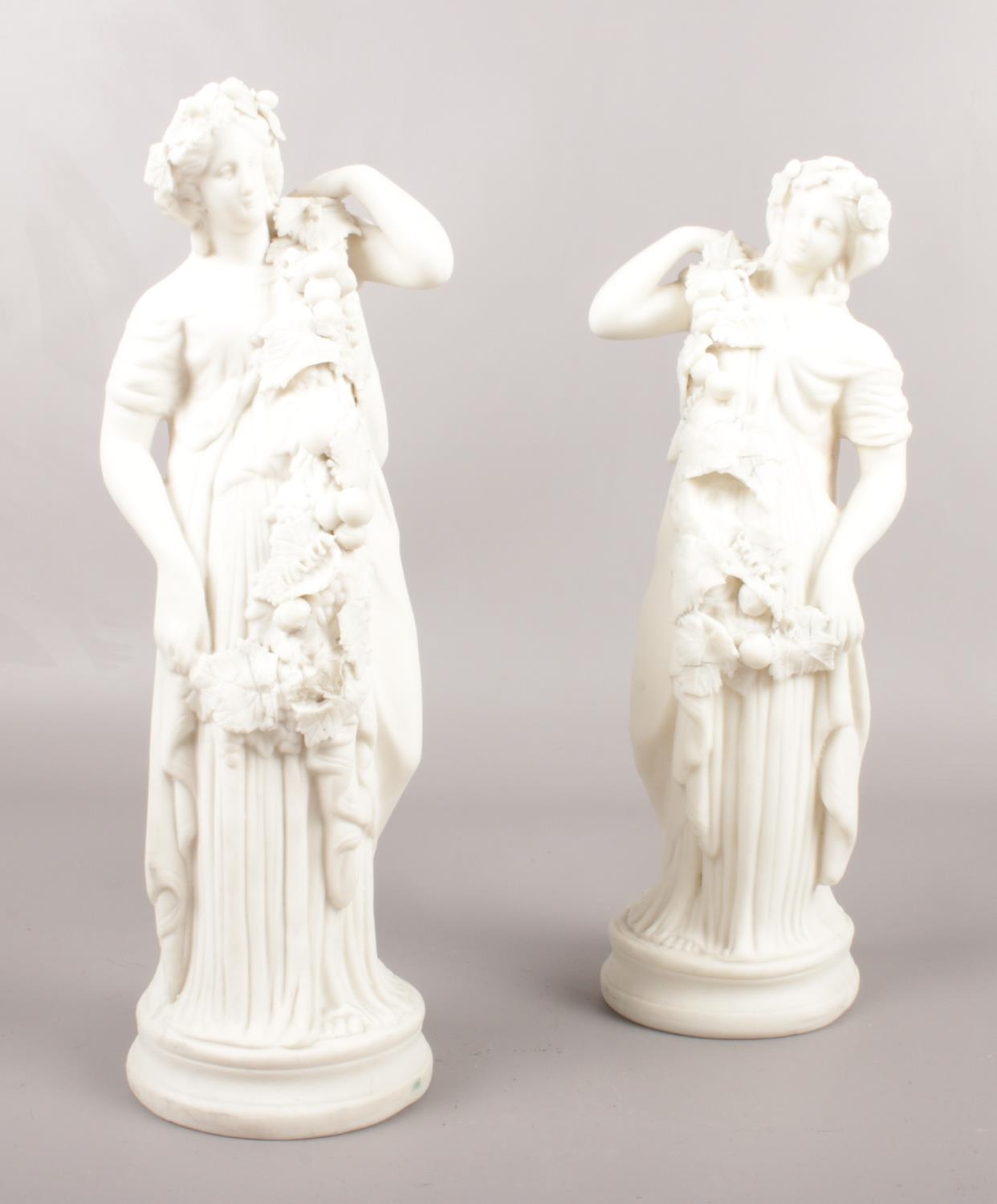 A pair of Bisque porcelain female figures. 27cm height.