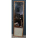 A tall gilt framed wall mirror. (178cm x 50cm)