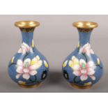 A pair of blue ground closonnie vases. Decorated with flowers. (11cm tall) Loss to enamel on under