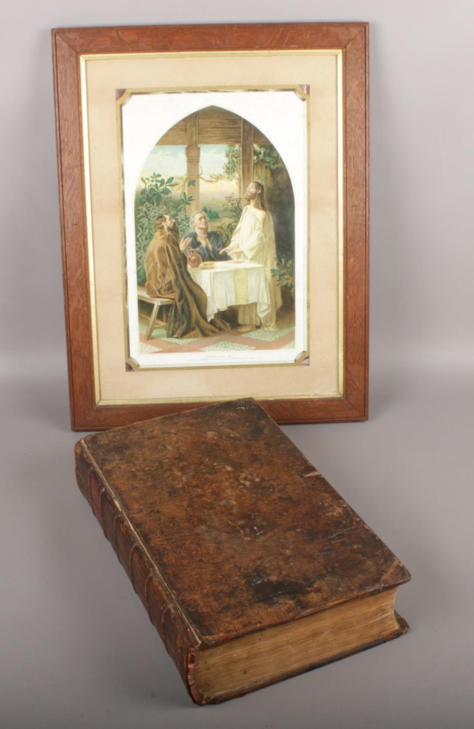 An 1810 leather bound family bible with monochrome plates along with a framed religious picture,