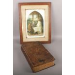 An 1810 leather bound family bible with monochrome plates along with a framed religious picture,