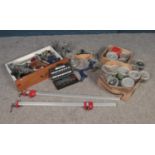 A drawer and two boxes of assorted hardware. To include various sized clamps and vices, a large