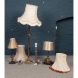 Four various lamps and shades. To include a brass adjustable floor lamp with shade and three