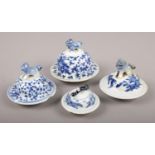 Four Chinese blue and white vase covers. Damage to all pieces.