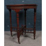 A Victorian Mahogany window table. Raised on turned legs with casters, joined by decorative