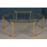 A hexagonal brass and glass coffee table. (39cm x 115cm)