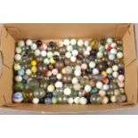 A box of glass and metal marbles.