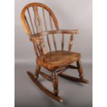 An ash/elm Windsor child's rocking chair.