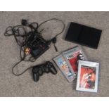 A Playstation 2 slimline console. With two games. Grand Theft Auto case empty. Unsure if in