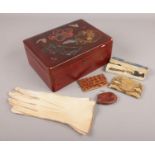 A lacquered oriental box with contents. Includes ladies leather gloves, purses, Coronation spoon.
