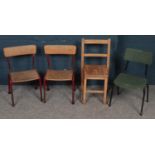 Four vintage children's school chairs.