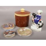 A small collection of pottery. Includes tobacco jar, pot lids, Staffordshire figure.