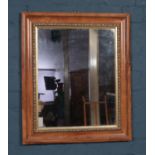 A mahogany and parcel gilt framed mirror. (66cm x 56cm).