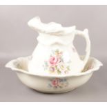A vintage ceramic jug & wash bowl, with floral pattern.